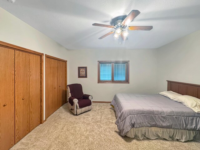 16 Pheasant Dr, Mason Twp, MN 56172 - bedroom with carpet, ceiling fan, and multiple closets