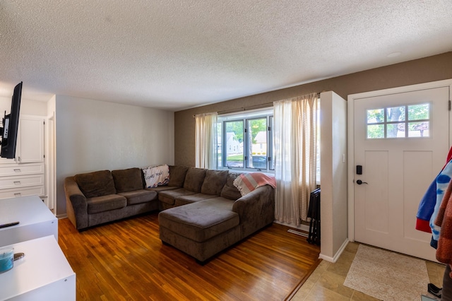 802 19th St SW, Austin, MN 55912 - living room with a textured ceiling, healthy amount of natural light, and light wood-type flooring