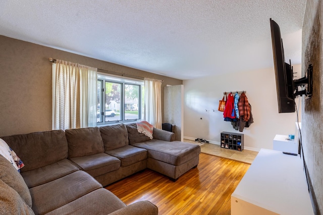 802 19th St SW, Austin, MN 55912 - living room with light wood-style floors, a textured ceiling, and baseboards