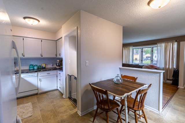 802 19th St SW, Austin, MN 55912 - kitchen with white dishwasher, a textured ceiling, tasteful backsplash, dark countertops, and open floor plan