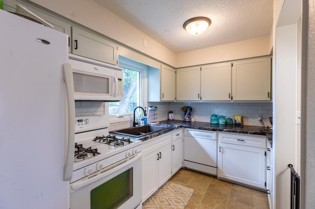 802 19th St SW, Austin, MN 55912 - kitchen with white appliances, backsplash, a sink, a textured ceiling, and dark countertops