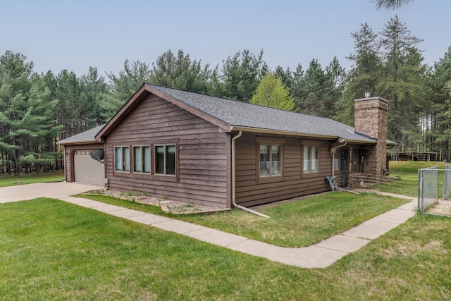 6563 Sandy Ln, Biwabik Twp, MN 55741 - view of home's exterior with a chimney, concrete driveway, a garage, and a shingled roof