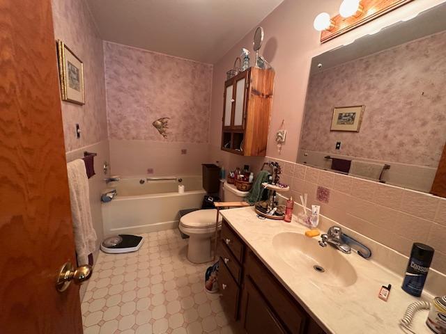 6563 Sandy Ln, Biwabik Twp, MN 55741 - full bathroom featuring tile patterned floors, vanity, a bath, and toilet