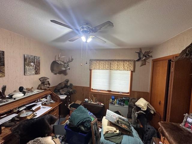 6563 Sandy Ln, Biwabik Twp, MN 55741 - misc room with wood walls, a ceiling fan, and a textured ceiling