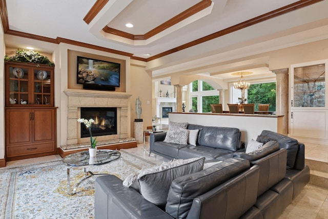 1910 Shoreline Dr, Orono, MN 55391 - living room featuring a premium fireplace, ornamental molding, a tray ceiling, a chandelier, and ornate columns
