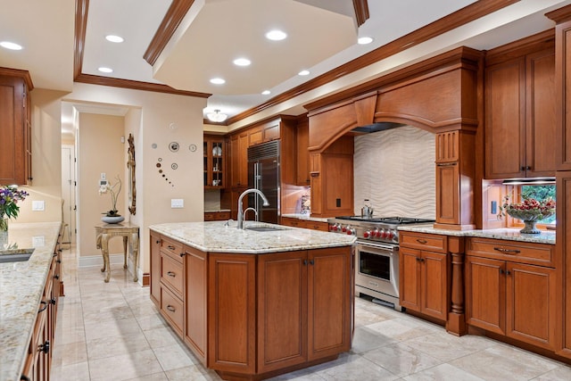 1910 Shoreline Dr, Orono, MN 55391 - kitchen featuring premium appliances, ornamental molding, backsplash, brown cabinetry, and a kitchen island with sink