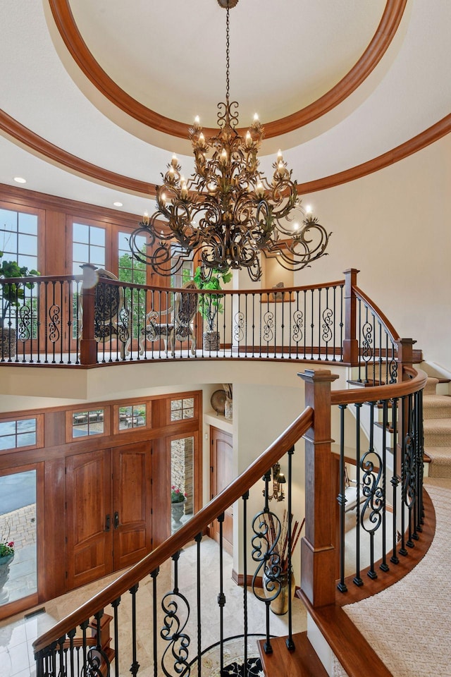 1910 Shoreline Dr, Orono, MN 55391 - staircase with ornamental molding, a chandelier, a tray ceiling, recessed lighting, and a high ceiling