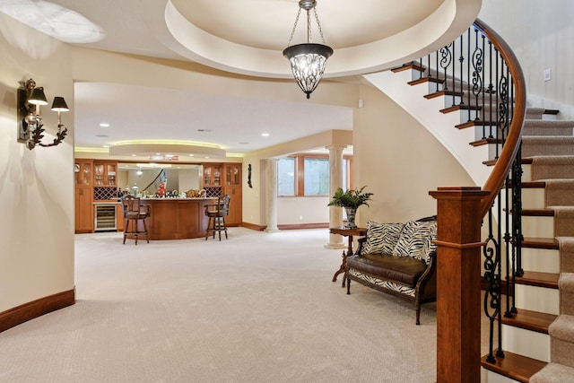 1910 Shoreline Dr, Orono, MN 55391 - foyer entrance featuring bar, light colored carpet, stairs, wine cooler, and ornate columns
