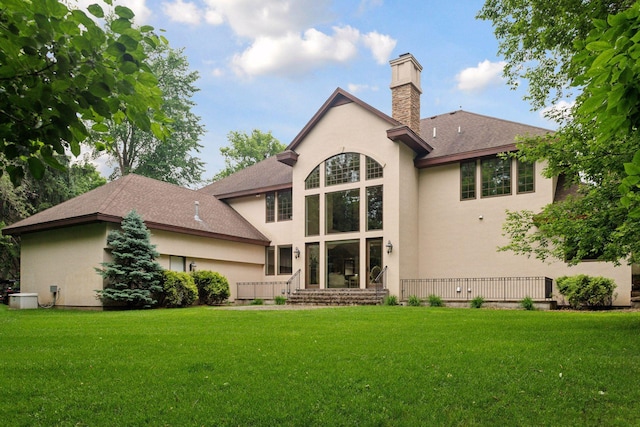 1910 Shoreline Dr, Orono, MN 55391 - back of property featuring stucco siding, a chimney, a yard, and roof with shingles