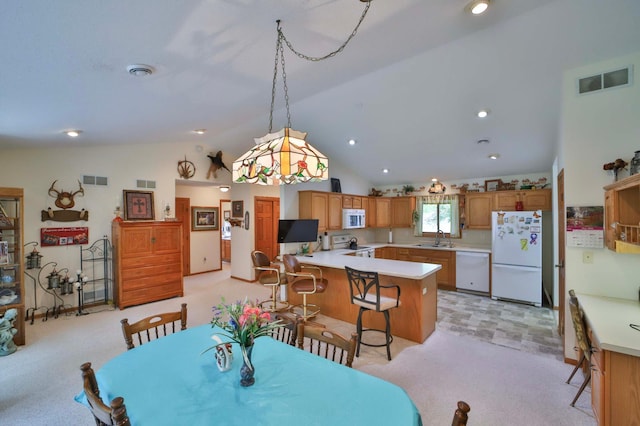 909 Lilac Ln, Little Falls, MN 56345 - dining room featuring light colored carpet and vaulted ceiling