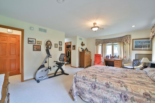 909 Lilac Ln, Little Falls, MN 56345 - bedroom featuring light carpet, baseboards, and a walk in closet