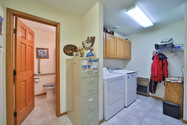 909 Lilac Ln, Little Falls, MN 56345 - laundry room with cabinet space, washing machine and clothes dryer, baseboards, a textured ceiling, and light tile patterned flooring