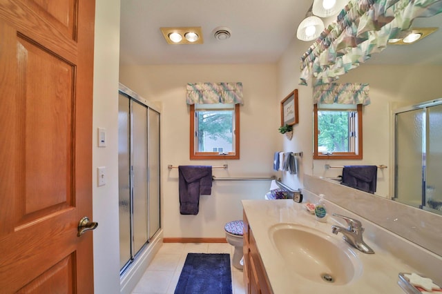 909 Lilac Ln, Little Falls, MN 56345 - bathroom featuring a shower stall, vanity, tile patterned floors, and toilet