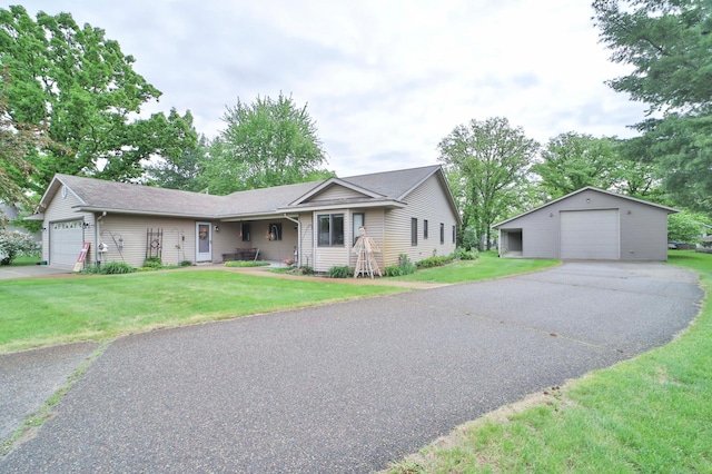 909 Lilac Ln, Little Falls, MN 56345 - ranch-style home with a detached garage, a front lawn, and an outbuilding
