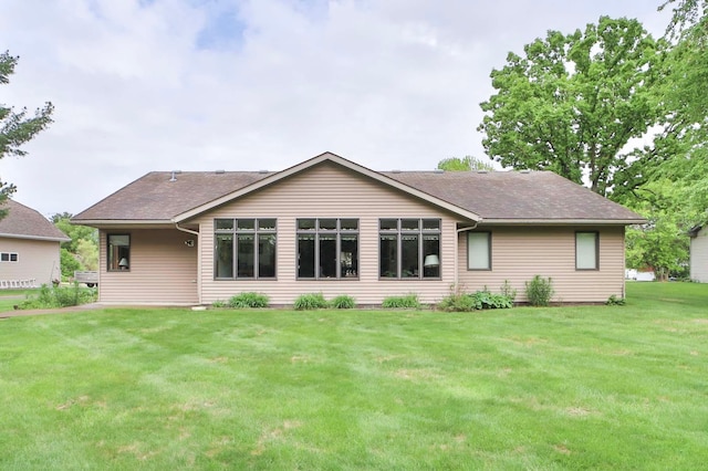 909 Lilac Ln, Little Falls, MN 56345 - back of property with a lawn and roof with shingles