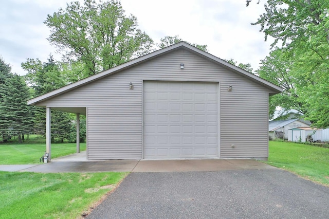 909 Lilac Ln, Little Falls, MN 56345 - detached garage featuring asphalt driveway