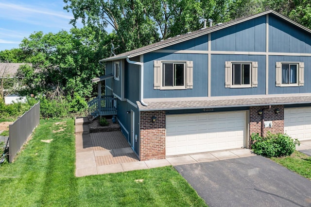 4252 Thornhill Ln, Vadnais Heights, MN 55127 - view of front facade featuring brick siding, a garage, asphalt driveway, and a shingled roof