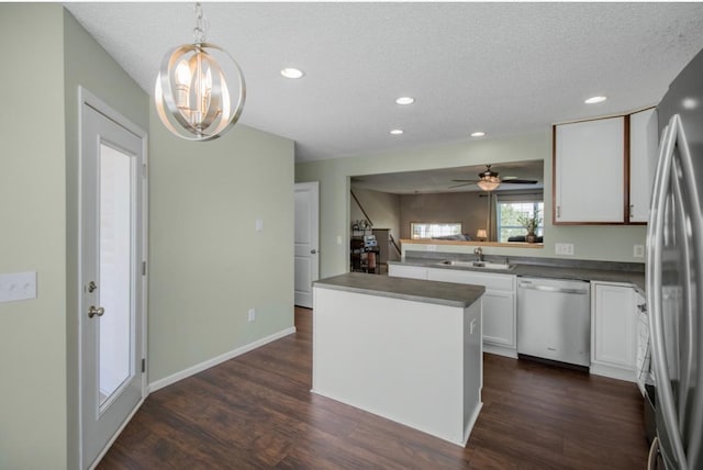5150 Fairpoint Dr N, Hugo, MN 55038 - kitchen featuring stainless steel appliances, a sink, dark wood-type flooring, white cabinetry, and a textured ceiling