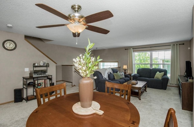 5150 Fairpoint Dr N, Hugo, MN 55038 - dining area with light carpet, a textured ceiling, and a ceiling fan