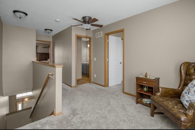 5150 Fairpoint Dr N, Hugo, MN 55038 - living area featuring an upstairs landing, carpet floors, a ceiling fan, baseboards, and a textured ceiling