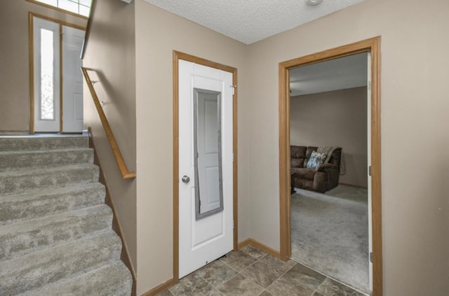 5150 Fairpoint Dr N, Hugo, MN 55038 - entryway with stairway, a textured ceiling, and baseboards
