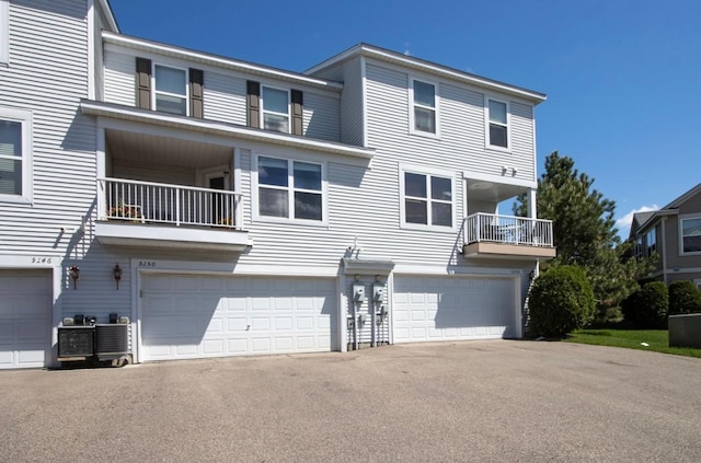 5150 Fairpoint Dr N, Hugo, MN 55038 - rear view of property featuring a balcony, an attached garage, and driveway