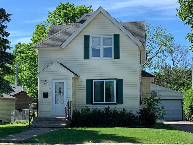 245 Mckinley St, Owatonna, MN 55060 - view of front facade with a garage and a shingled roof