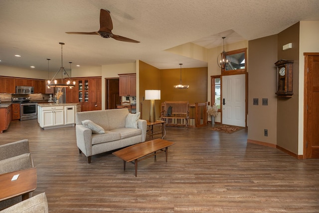 2373 Tee Time Rd SE, Rochester, MN 55904 - living room with a chandelier, wood finished floors, ceiling fan, baseboards, and a textured ceiling