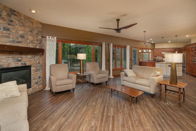 2373 Tee Time Rd SE, Rochester, MN 55904 - living room featuring wood finished floors, a ceiling fan, a stone fireplace, and recessed lighting