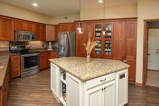 2373 Tee Time Rd SE, Rochester, MN 55904 - kitchen featuring appliances with stainless steel finishes, brown cabinets, dark wood-style floors, backsplash, and light stone countertops