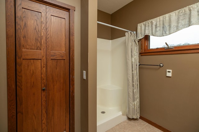2373 Tee Time Rd SE, Rochester, MN 55904 - full bath featuring a shower with shower curtain, baseboards, and tile patterned flooring
