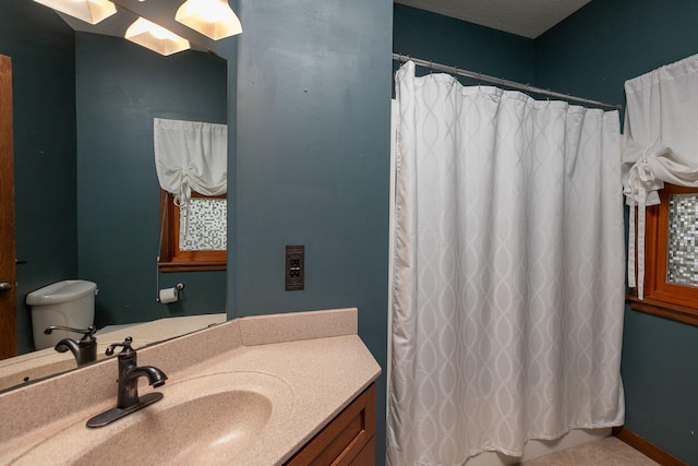 2373 Tee Time Rd SE, Rochester, MN 55904 - bathroom featuring vanity, a shower with curtain, tile patterned floors, and toilet