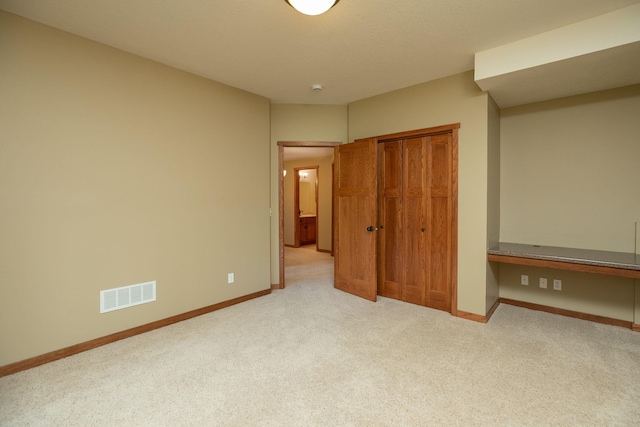 2373 Tee Time Rd SE, Rochester, MN 55904 - unfurnished bedroom with carpet, a closet, and baseboards