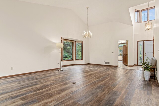 1263 Silverthorn Dr, Shoreview, MN 55126 - unfurnished living room featuring a chandelier, wood finished floors, baseboards, and high vaulted ceiling