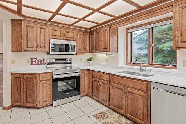 1263 Silverthorn Dr, Shoreview, MN 55126 - kitchen with appliances with stainless steel finishes, a sink, light countertops, and brown cabinetry