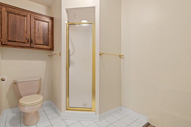 1263 Silverthorn Dr, Shoreview, MN 55126 - bathroom featuring a stall shower, toilet, and tile patterned floors