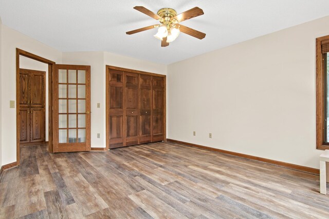 1263 Silverthorn Dr, Shoreview, MN 55126 - unfurnished bedroom with wood finished floors, baseboards, and a closet