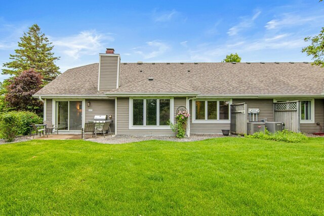 1263 Silverthorn Dr, Shoreview, MN 55126 - back of house with a patio area, a chimney, central AC, and a yard