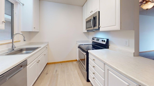 1904 Greenview Pl SW, Rochester, MN 55902 - kitchen with appliances with stainless steel finishes, a sink, light wood finished floors, white cabinetry, and light countertops