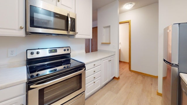1904 Greenview Pl SW, Rochester, MN 55902 - kitchen featuring appliances with stainless steel finishes, light wood-style flooring, light countertops, and white cabinets