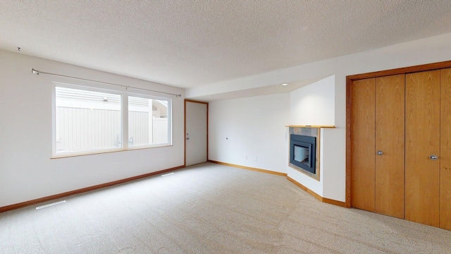 1904 Greenview Pl SW, Rochester, MN 55902 - unfurnished living room featuring carpet, a glass covered fireplace, baseboards, and a textured ceiling