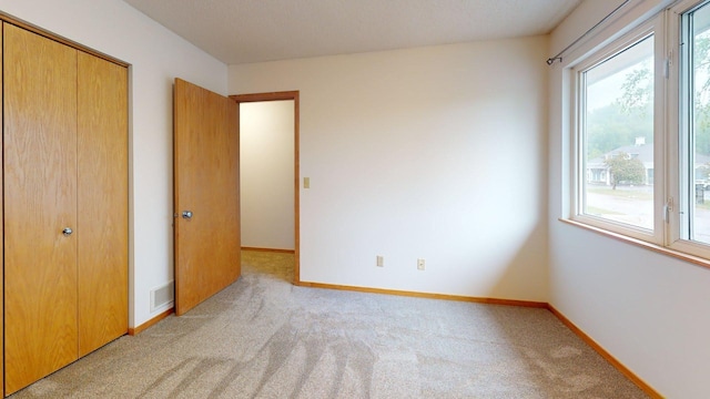 1904 Greenview Pl SW, Rochester, MN 55902 - unfurnished bedroom with multiple windows, light colored carpet, and baseboards