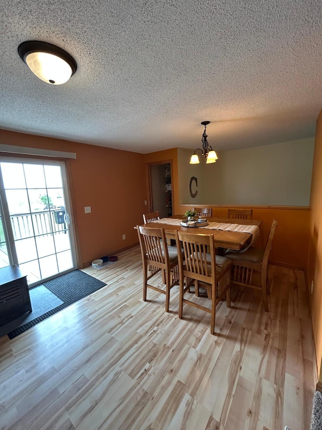 900 Pleasant Ave S, Park Rapids, MN 56470 - dining room featuring a chandelier, a textured ceiling, and light wood-style floors