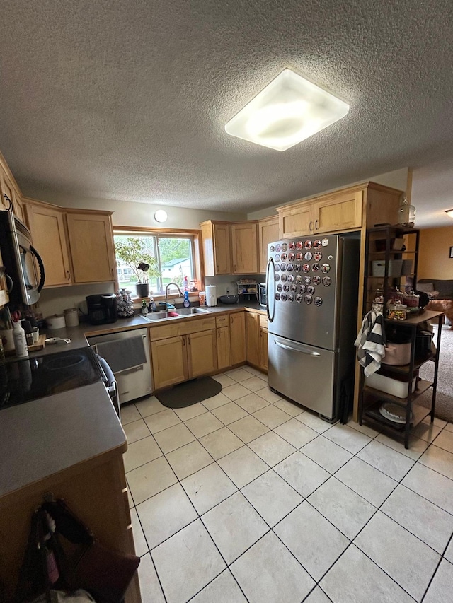900 Pleasant Ave S, Park Rapids, MN 56470 - kitchen featuring appliances with stainless steel finishes, a sink, a textured ceiling, light tile patterned flooring, and light brown cabinets