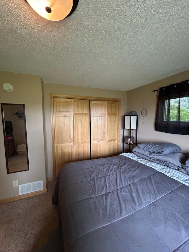 900 Pleasant Ave S, Park Rapids, MN 56470 - bedroom featuring a textured ceiling, a closet, baseboards, and carpet