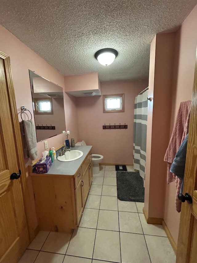 900 Pleasant Ave S, Park Rapids, MN 56470 - bathroom featuring toilet, vanity, tile patterned flooring, a textured ceiling, and a shower with shower curtain