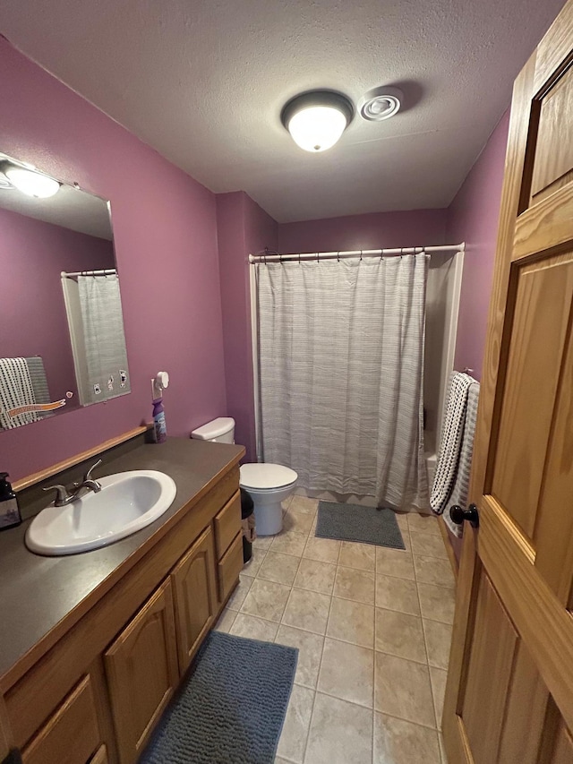 900 Pleasant Ave S, Park Rapids, MN 56470 - bathroom featuring vanity, toilet, a textured ceiling, tile patterned flooring, and shower / bathtub combination with curtain