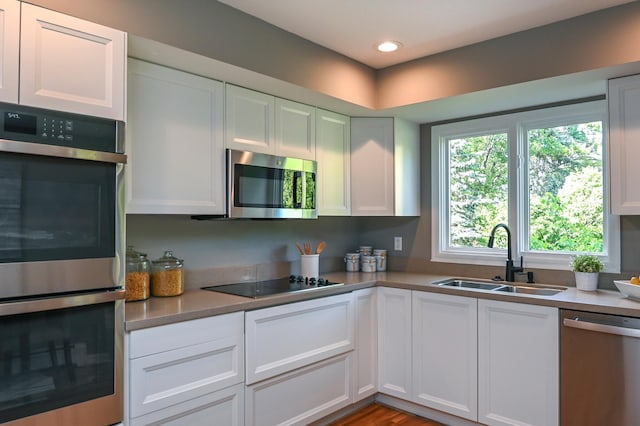 4020 Orleans Ln N, Plymouth, MN 55441 - kitchen featuring stainless steel appliances, a sink, white cabinetry, light countertops, and recessed lighting