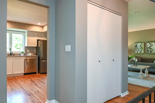 4020 Orleans Ln N, Plymouth, MN 55441 - hallway with light wood-style floors, a sink, and recessed lighting