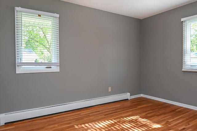 4020 Orleans Ln N, Plymouth, MN 55441 - spare room featuring baseboard heating, wood finished floors, and baseboards